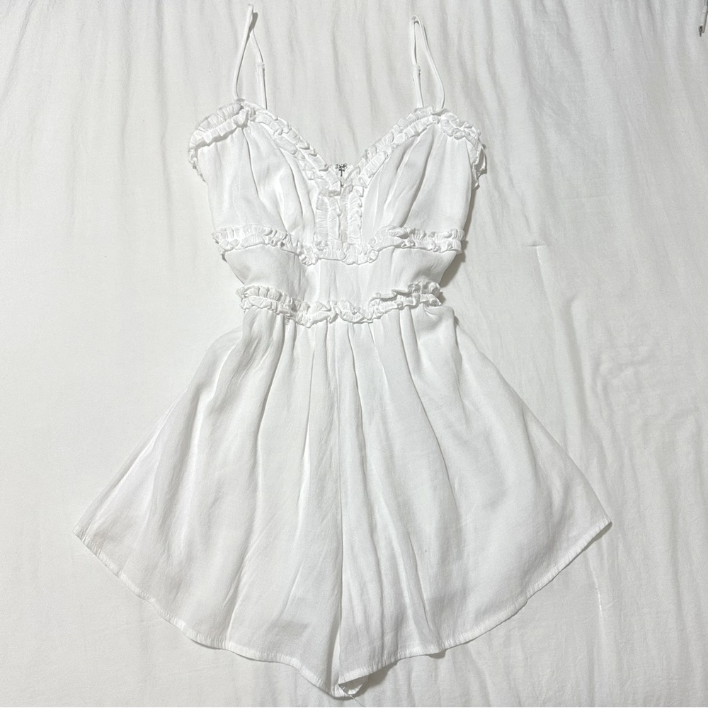 white romper with ruffle detailing